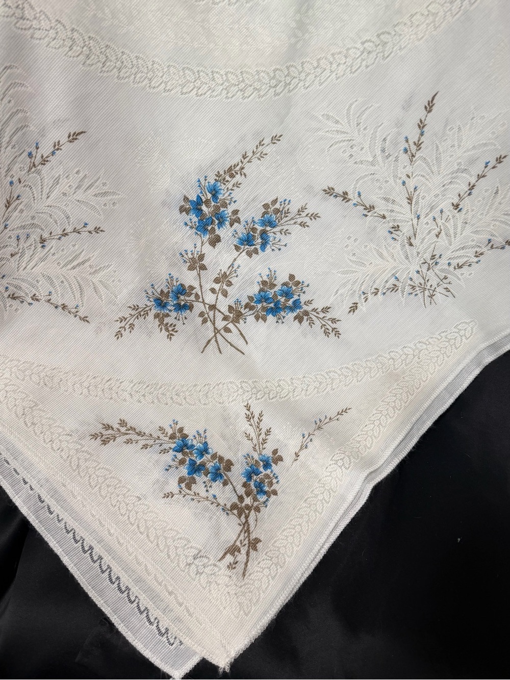 Vintage White Floral tablecloth with Blue Flowers fits a long rectangular table.